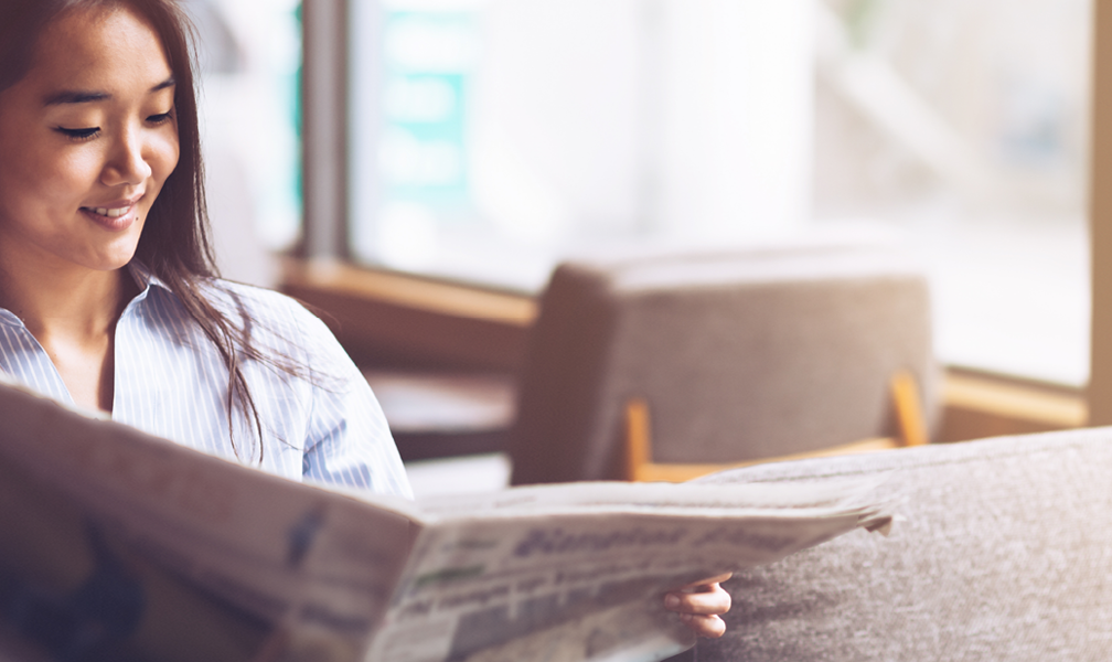 A women reading a newspaper